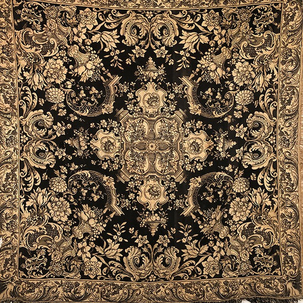 Antique tapestry or table cloth on a black background with rich decorations of Medici vases and flowers