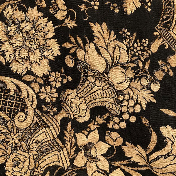 Antique tapestry or table cloth on a black background with rich decorations of Medici vases and flowers