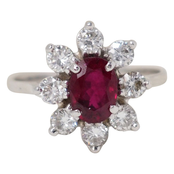 Surrounding ring in white gold, oval ruby and diamonds