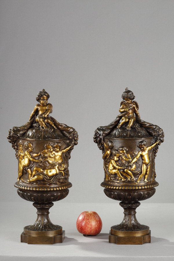 PAIR OF COVERED VASES, IN FINELY CHASED BRONZE WITH A RICH ROTATING DECORATION