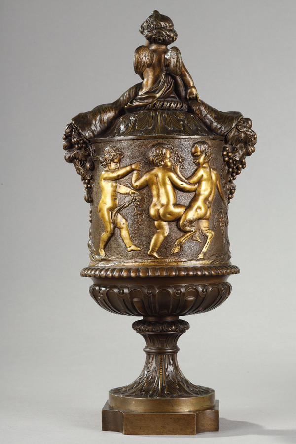 PAIR OF COVERED VASES, IN FINELY CHASED BRONZE WITH A RICH ROTATING DECORATION