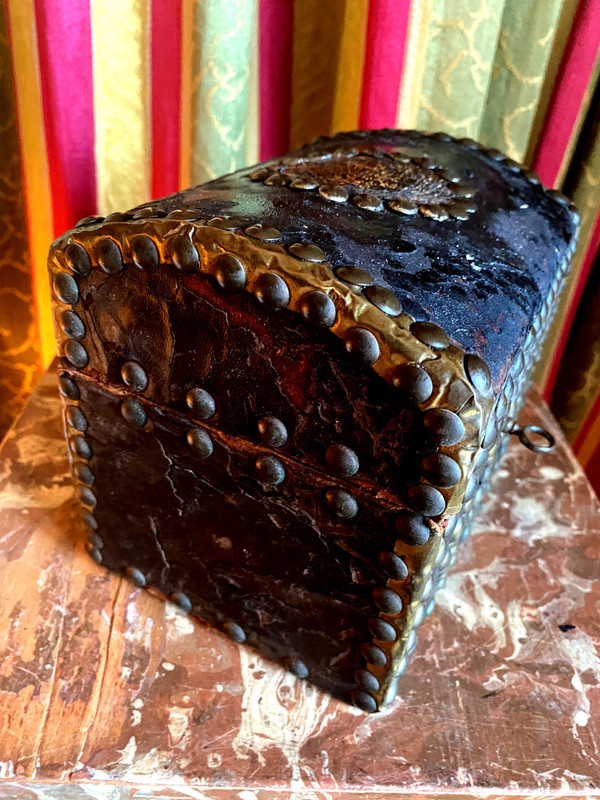 Very old wooden cassette covered in leather studded with the Arms of a Knight from the early 18th century