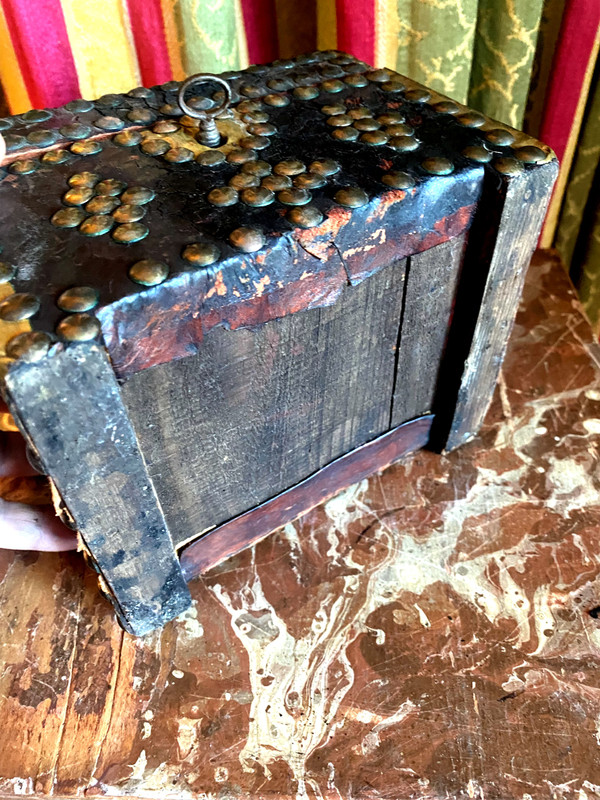 Very old wooden cassette covered in leather studded with the Arms of a Knight from the early 18th century