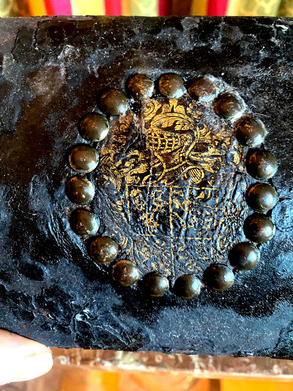 Very old wooden cassette covered in leather studded with the Arms of a Knight from the early 18th century