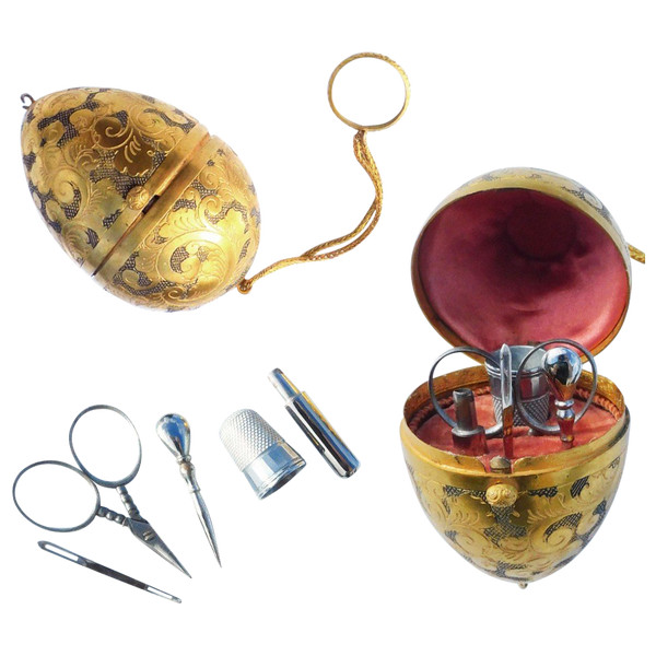 Miniature steel sewing kit in a golden metal egg-shaped box