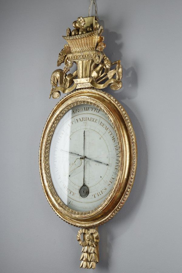 Barometer-thermometer in gilt wood, Louis XVI period
