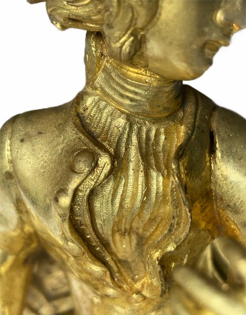 Pair of Louis XV style gilt bronze andirons representing a couple seated on rockery