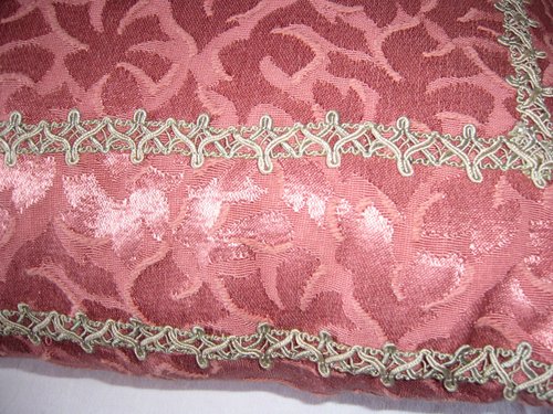 Damask and braid cushion