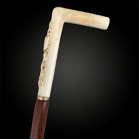 WALKING CANE probably of a woman carved with flowers - European work from the beginning of the 20th century