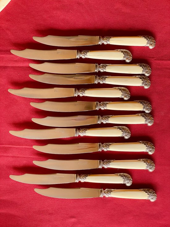 24 table knives with ivory handles and desserts.