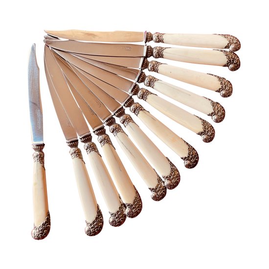 24 table knives with ivory handles and desserts.