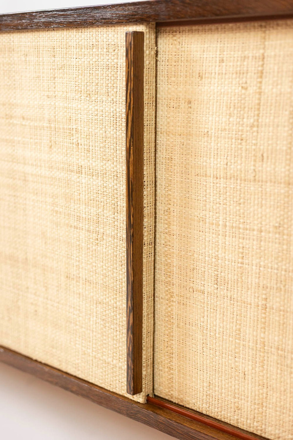 Sideboard in wenge, raffia and lacquered metal. 1970s.