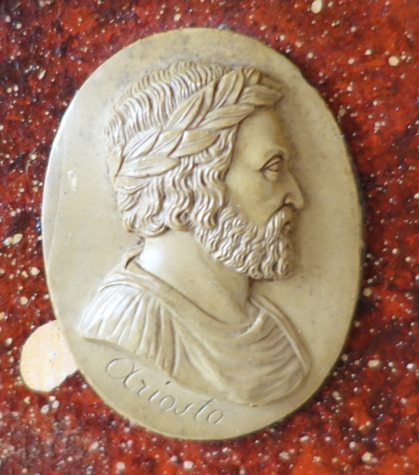 Antique cameos in an Empire frame, souvenir of the Grand Tour on a porphyry background