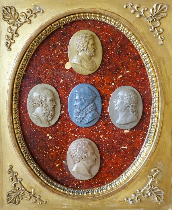 Antique cameos in an Empire frame, souvenir of the Grand Tour on a porphyry background