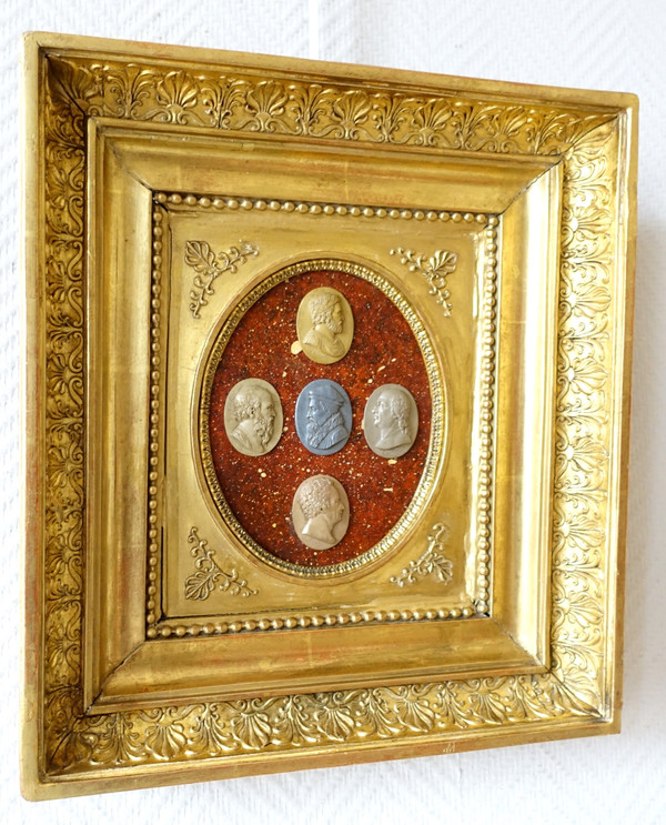 Antique cameos in an Empire frame, souvenir of the Grand Tour on a porphyry background