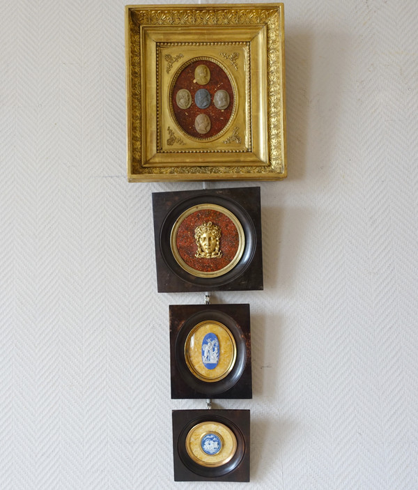 Antique cameos in an Empire frame, souvenir of the Grand Tour on a porphyry background
