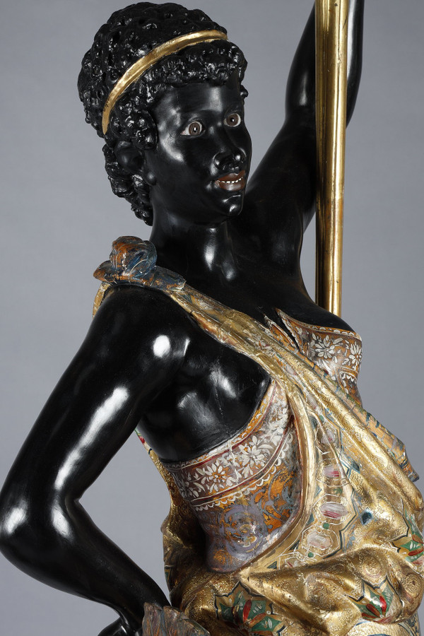 PAIR OF BLACK AND POLYCHROME LACQUERED WOOD TORCHHOLDERS DEPICTING NUBIANS