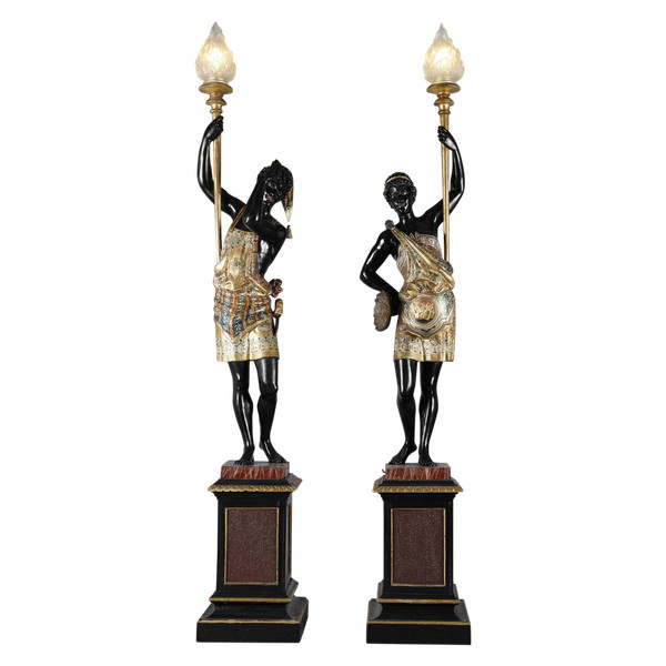 PAIR OF BLACK AND POLYCHROME LACQUERED WOOD TORCHHOLDERS DEPICTING NUBIANS