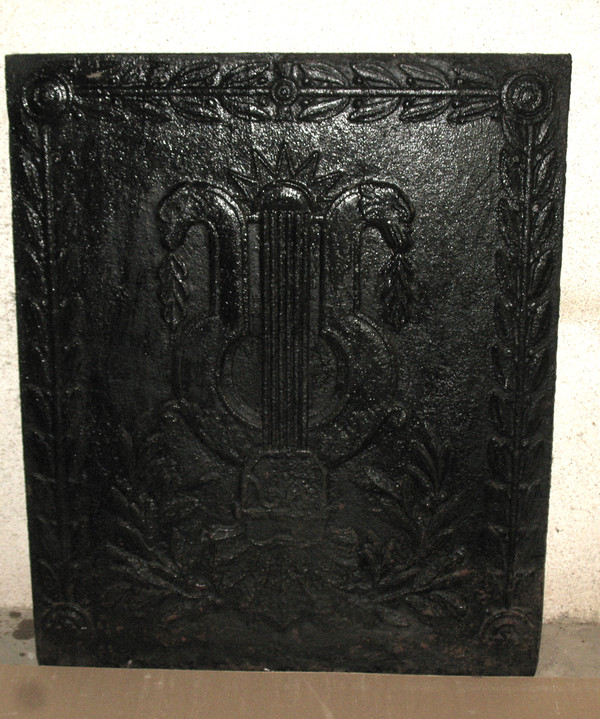 Large cast-iron fireback from the 18th century decorated with coat of arms and lyre