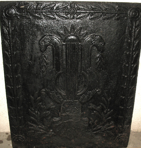 Large cast-iron fireback from the 18th century decorated with coat of arms and lyre