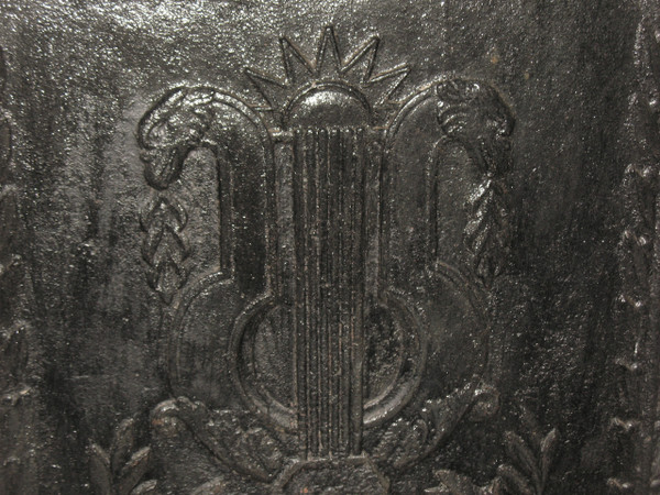 Large cast-iron fireback from the 18th century decorated with coat of arms and lyre
