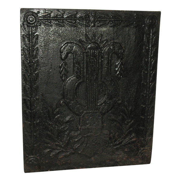Large cast-iron fireback from the 18th century decorated with coat of arms and lyre