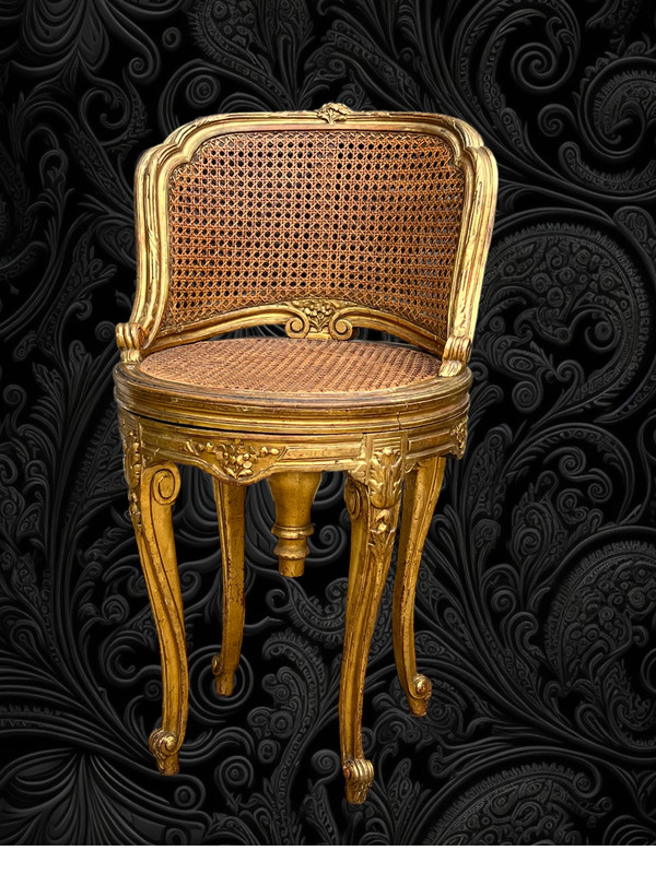 FAUTEUIL TOURNANT COURBÉ EN BOIS DORÉ ET CANNAGE DU XIXe DE STYLE LOUIS XV