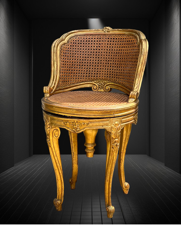 FAUTEUIL TOURNANT COURBÉ EN BOIS DORÉ ET CANNAGE DU XIXe DE STYLE LOUIS XV