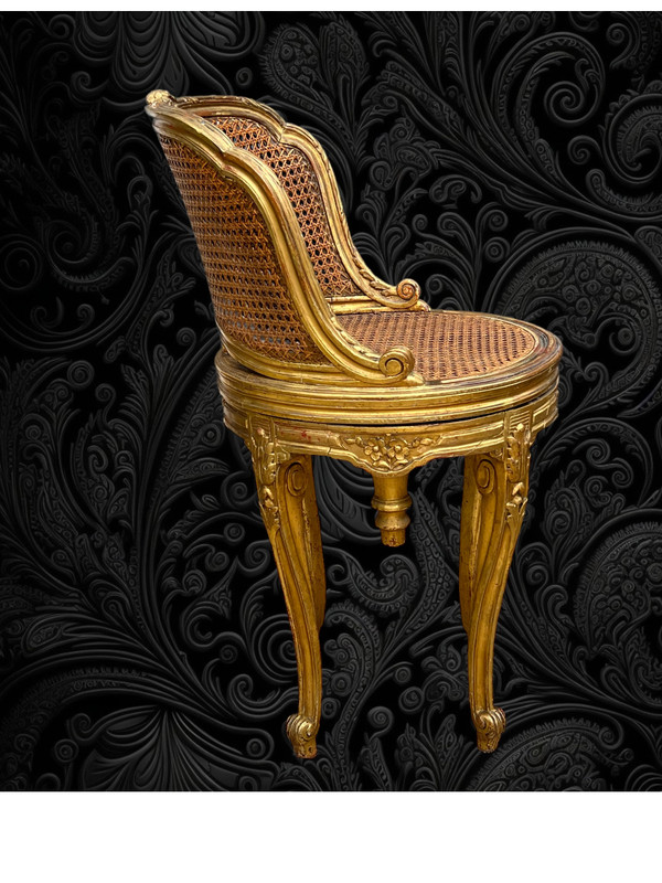 FAUTEUIL TOURNANT COURBÉ EN BOIS DORÉ ET CANNAGE DU XIXe DE STYLE LOUIS XV