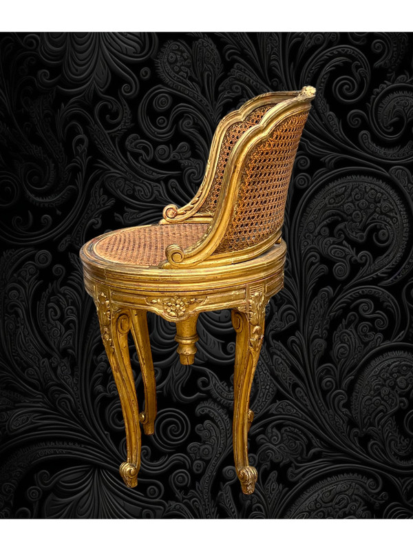 FAUTEUIL TOURNANT COURBÉ EN BOIS DORÉ ET CANNAGE DU XIXe DE STYLE LOUIS XV