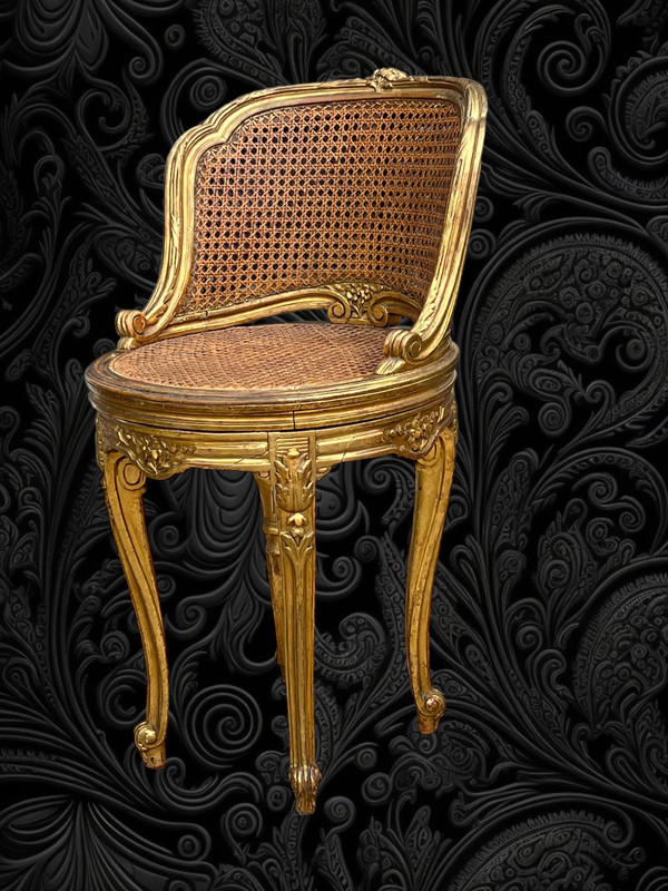 FAUTEUIL TOURNANT COURBÉ EN BOIS DORÉ ET CANNAGE DU XIXe DE STYLE LOUIS XV