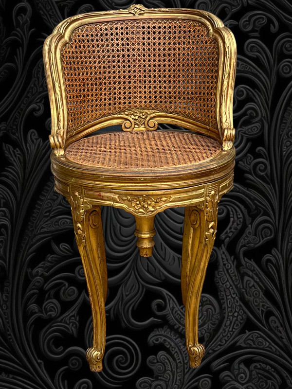 FAUTEUIL TOURNANT COURBÉ EN BOIS DORÉ ET CANNAGE DU XIXe DE STYLE LOUIS XV