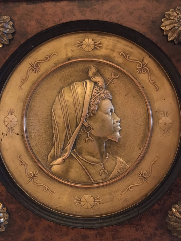 Pair of chased and gilded copper medallions, signed P. Faraoni (1869)