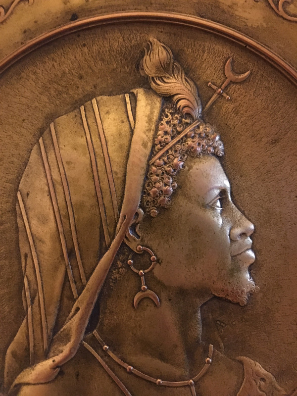 Pair of chased and gilded copper medallions, signed P. Faraoni (1869)