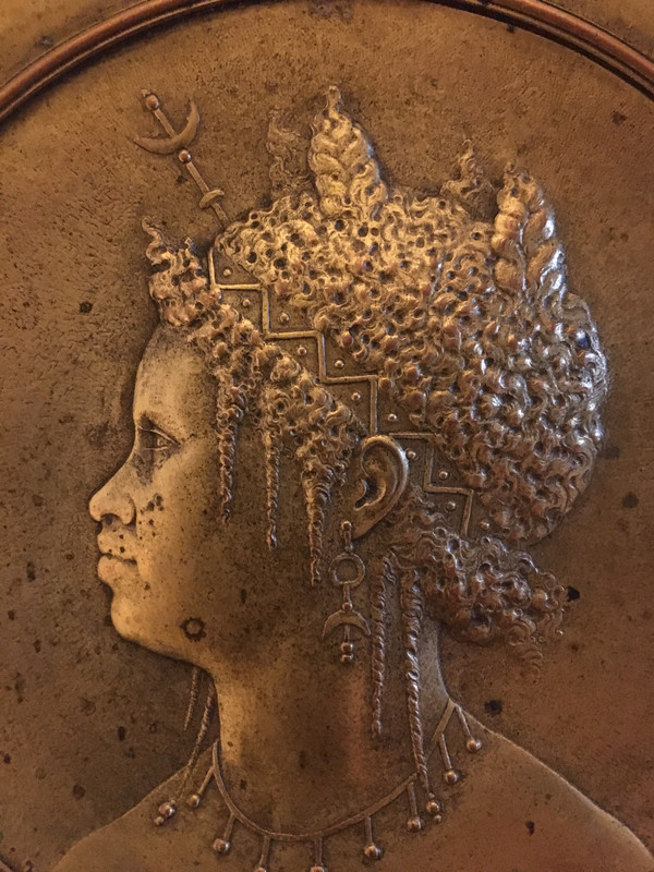 Pair of chased and gilded copper medallions, signed P. Faraoni (1869)