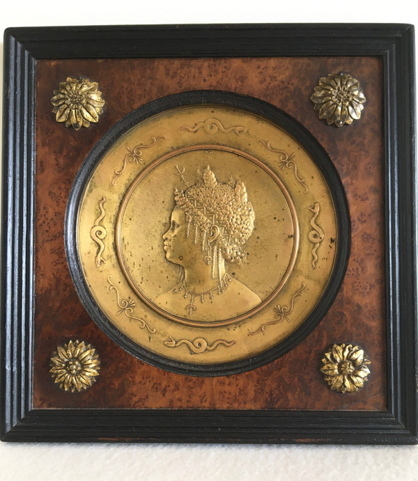 Pair of chased and gilded copper medallions, signed P. Faraoni (1869)