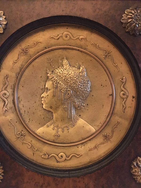 Pair of chased and gilded copper medallions, signed P. Faraoni (1869)