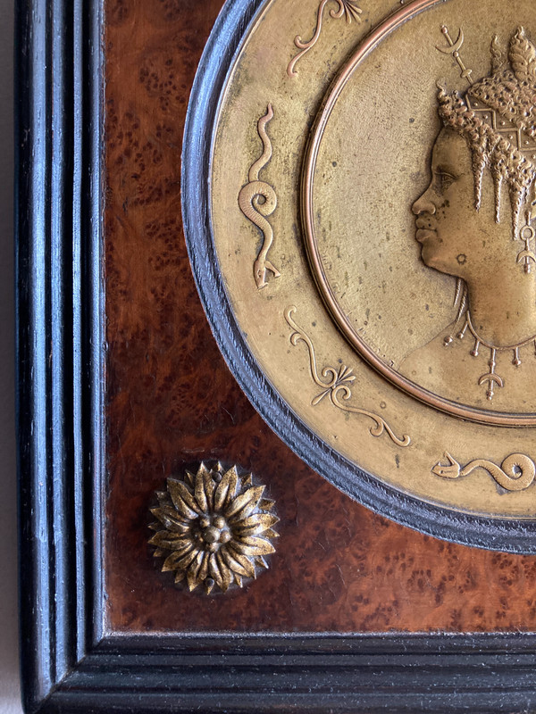 Pair of chased and gilded copper medallions, signed P. Faraoni (1869)