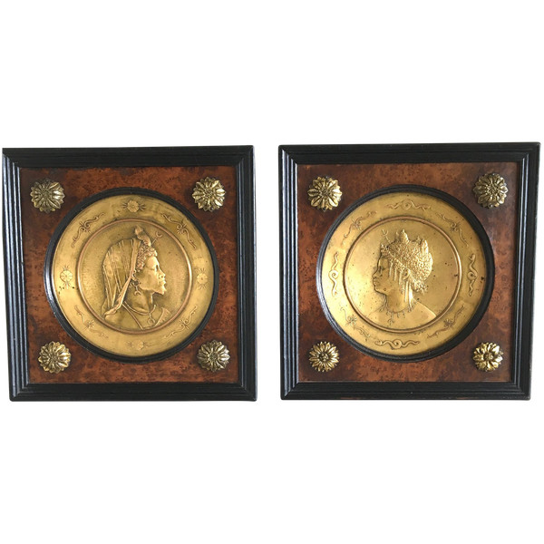 Pair of chased and gilded copper medallions, signed P. Faraoni (1869)