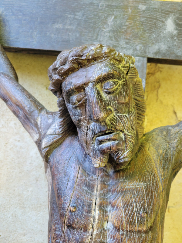 Large carved wooden Christ with inclined head surrounded by a crown of thorns 17th century