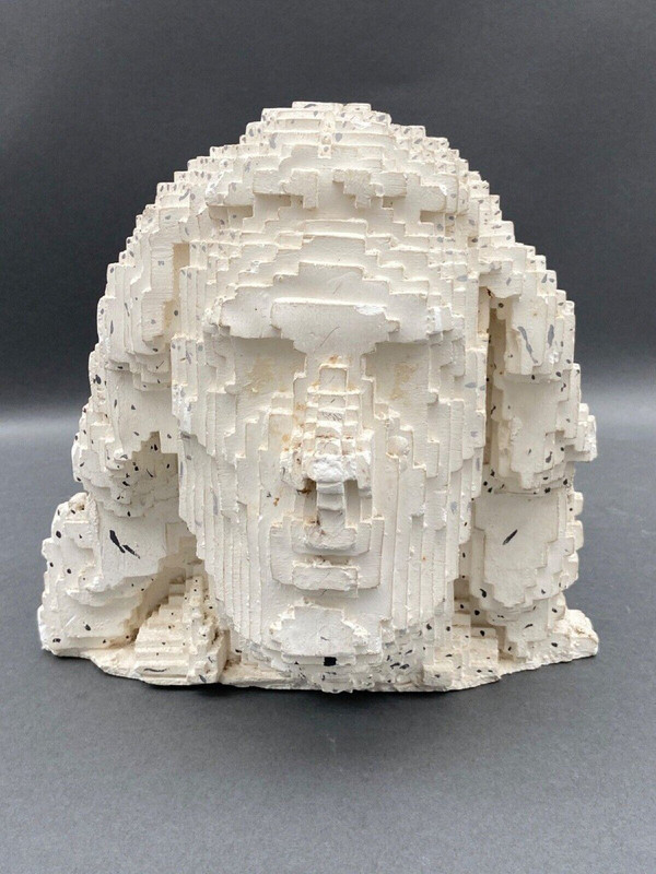 Sculpture in cellular concrete, pixelation of a man's face 1970