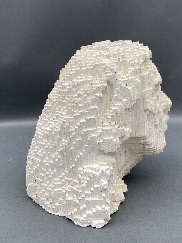 Sculpture in cellular concrete, pixelation of a man's face 1970