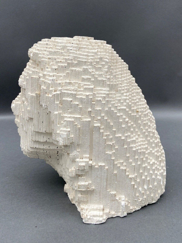 Sculpture in cellular concrete, pixelation of a man's face 1970