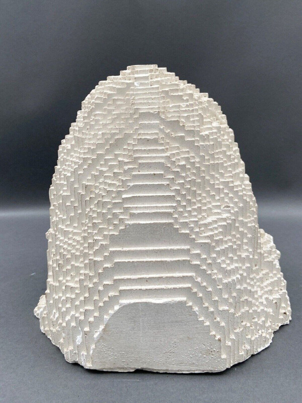 Sculpture in cellular concrete, pixelation of a man's face 1970