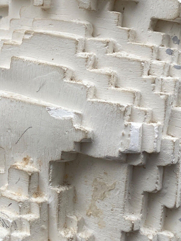 Sculpture in cellular concrete, pixelation of a man's face 1970