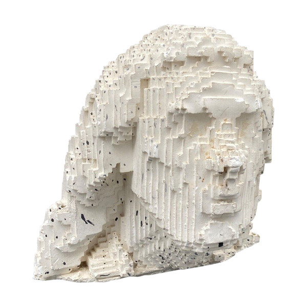 Sculpture in cellular concrete, pixelation of a man's face 1970