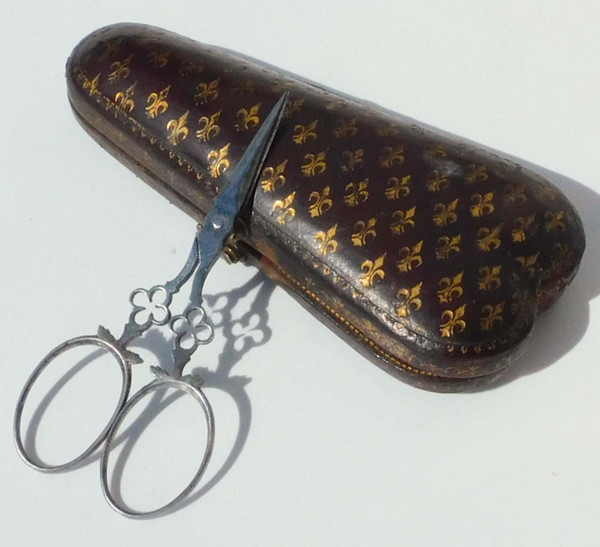 Small pair of steel embroidery sewing scissors in its 19th century leather-covered case