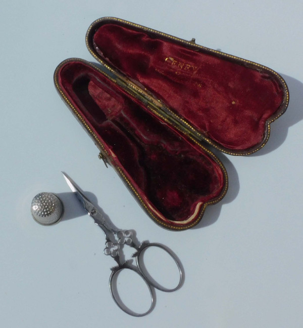 Small pair of steel embroidery sewing scissors in its 19th century leather-covered case