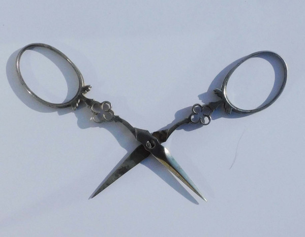 Small pair of steel embroidery sewing scissors in its 19th century leather-covered case