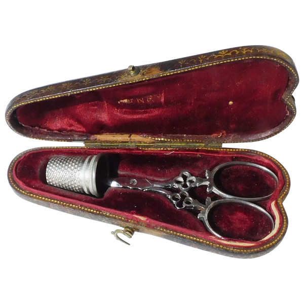 Small pair of steel embroidery sewing scissors in its 19th century leather-covered case